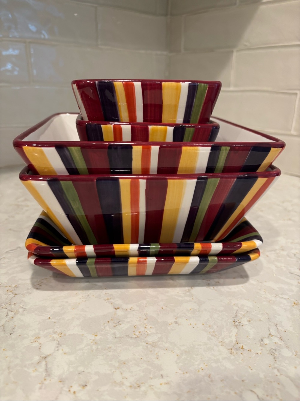 The Pampered Chef striped ceramic set in burgundy, yellow, orange, green, navy